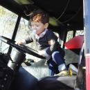 Declan Ferreira, 2, of Somerset climbs into a Mattapoisett fire truck.