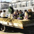 Fall fest attendees hop onto a hay ride.