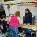 Bridget Coryer helps students with their crafts.