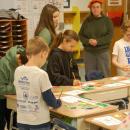 High schoolers help out some younger students.