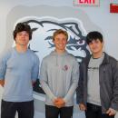 James Russell, Luke Pierre and Rafael Duarte, 3 class officers who created the cookbook, pose infront of an Old Rochester Bulldog. Photo by Mari Huglin