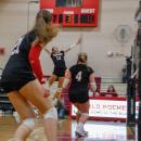 Molly Franco leaping to hit a ball.