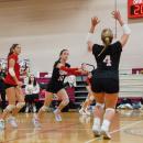 Molly Morrison sets the ball as Hadley King gets ready to jump and spike.