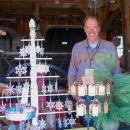 A Red Oak Garden volunteer smiles in front of his table.