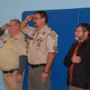 The Boy Scout troupe leaders honor the flag. 
