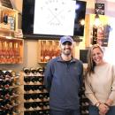 Joel Sullivan of Rochester and Niki Ashley stand together in J. Sull Wine, a new business they opened, in Marion. Photo by Grace Ann Natanawan