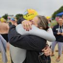Emma Whittaker’s parents, Phil and Jess embrace after the Buzzards Bay Swim on Jun. 28. Emma’s parents continue to fundraise to support Buzzards Bay and the environment in her honor. Source: Rebecca Cusick 