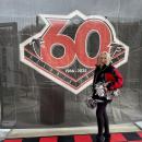 Elaine Botelho poses infront of a 60th anniversary poster. Source: Elaine Botelho