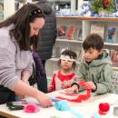 Macy Davis guides young visitors through making a streamer wand. 
