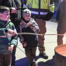 A young attendee roasts a marshmallow over a flame.  