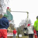 Community members look on as the hat is installed. 
