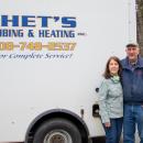 Debra Rusinoski, left, and Chet pose in front of one of their trucks outside their Marion office. Their family business closed this year after 45 years of business. Photo by Bobby Grady