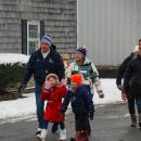 Families trekked through the snow to see Santa on a boat.