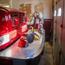 A fire truck is parked inches from the garage door.