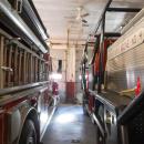 Fire engines are parked extremely close to one another.