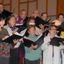 The choir warms up their vocals before heading into a song.