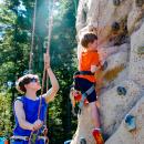 Kieran Adams climbs up a rock wall while being belayed by a Carabiner's Climbing Gym employee at the Old Colony Fall Family Festival on Saturday, Oct. 4. Photo by Mari Huglin 