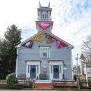 Colorful triangles of sailcloth adorn the outside of the Marion Art Center. 