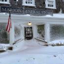 Strong gusts of wind blew snow onto buildings and covered windows, including at the Marion General Store. Photo source: Tucker Burr