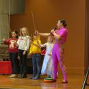Liu teaches young volunteers how to keep plates spinning on a stick. 