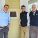 From left: Joshua Fischer, Gerry Riker and Will Tifft stand outside the Captain Hadley House. Photos by Grace Roche