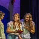 Sophie tells her friends Lisa, left, played by Kennedy McKay, and Ali, right, played by Tenley Lane, that she secretly invited her possible fathers to the wedding.  