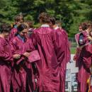 Students embrace and celebrate after the ceremony. 