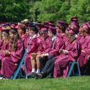Rows of graduates wait for their names to be called. 