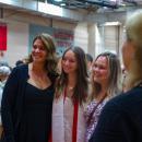 A graduate poses for a photo. 