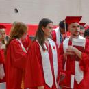 Graduated students head out of the gym. 