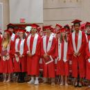 The crowd cheered as the graduating class stood together. 