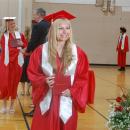 Students shake hands with school administrators and pose for photos during the ceremony. 