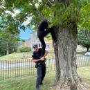 Sgt. Connor Leddin holds up Connolly as she reaches for the young animal. 
