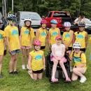 Classmates and friends surround Vivian Jones, center, at the June 2025 Kids Pan-Mass Challenge, a bike-a-thon that raises money for cancer research and treatment. Photos source: Jennifer Jones.