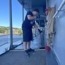 Bryan Correia paints the deck of a boat at Battleship Cove. 