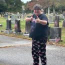 Cole Gretton poses in front of some of the graves he cleaned. 