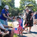 Evelyn Hussey, 6, and Valerie Hussey, 6, grab candy thrown along the parade route. 