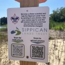 A sign shares information on how to use the post and how to access panoramic photos. 