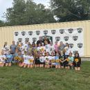 Madelyn's former teammates smile for a photo with her family.