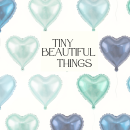 Small image that shows metallic balloons of different colours and the phrase "Tiny Beautiful Things"