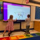 Students play in the Project GROW room, the school's preschool program. 