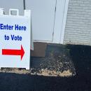 A sign guides voters to the polls. 