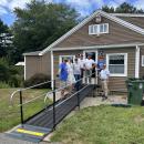 The Lions Club crew smiles around the completed ramp. 