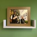 Reilley displays a photo of her former business partner Rich Wolfe in her office at the farm. 