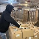 One employee prepares packages of sprouts for distribution. 