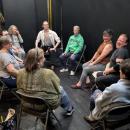 A circle of actors gets ready to IMPROV