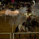 A rider shoots a gun during the Sept. 19 rodeo. Photo by Benjamin Martins