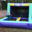 Cash Elder swinging at the inflatable tee ball game.