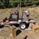 Several older pieces of dry harvesting equipment are displayed on the farm.