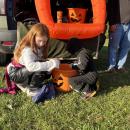 Kids take candy from one of the decorated car displays. 